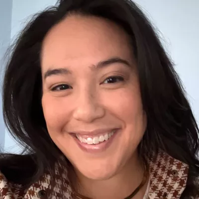 A woman smiles at the camera