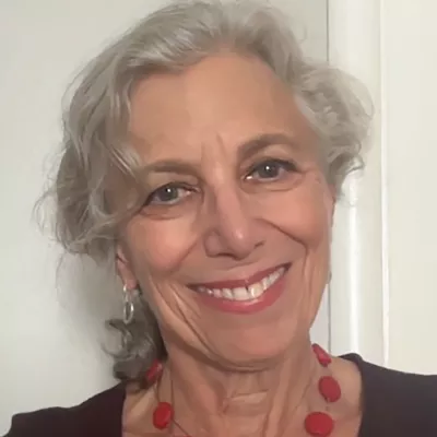 A woman smiles at the camera