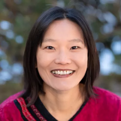 A woman smiles at the camera