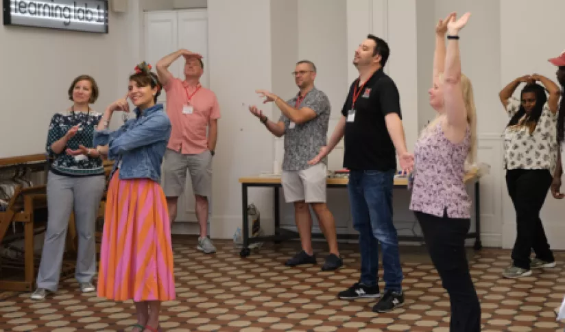 A group of adults make body movements